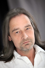 Image showing Serious unshaven man with long hair