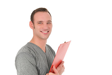 Image showing Handsome smiling man holding a clipboard