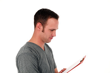 Image showing Man reading notes on a clipboard