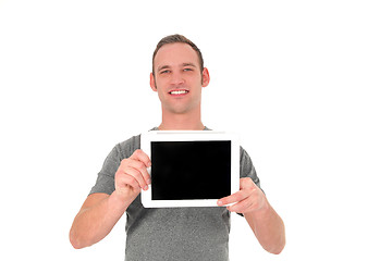 Image showing Smiling young man showing his tablet