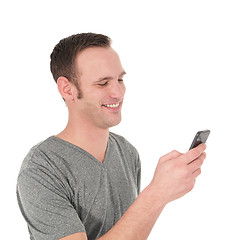 Image showing Happy young man reading a text message