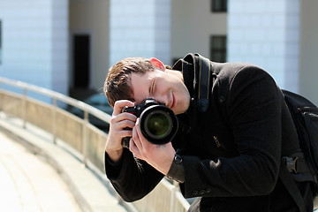 Image showing Young man in black coat