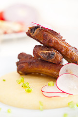 Image showing pork ribbs on polenta corn cream bed