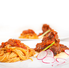 Image showing pasta with pork ribbs sauce on polenta bed