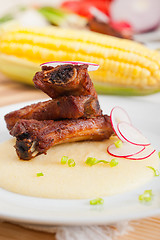 Image showing pork ribbs on polenta corn cream bed