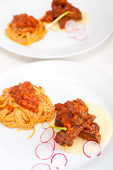 Image showing pasta with pork ribbs sauce on polenta bed