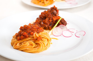 Image showing pasta with pork ribbs sauce on polenta bed