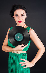 Image showing Pretty girl holding vinyl disc