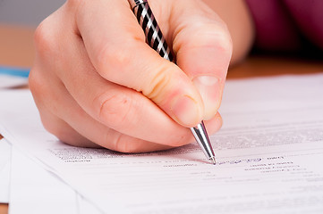 Image showing Woman writing in organizer