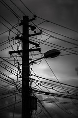 Image showing Photo of an electric pole with a many cables