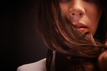 Image showing Young woman against dark background