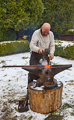 Image showing Blacksmith Working Outside in Winter