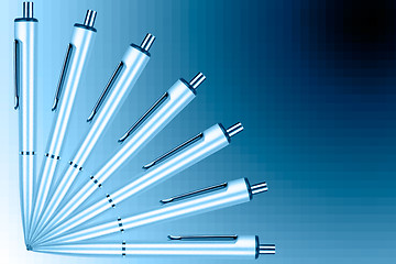 Image showing Fan of pens on a blue graduated background