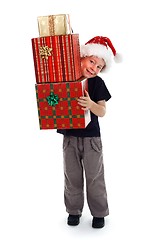 Image showing Smiling boy holding presents