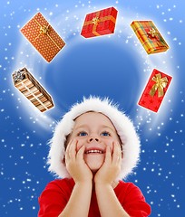 Image showing Boy looking to copy space surrounded by gifts