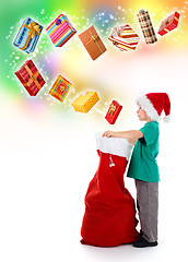 Image showing Little boy opening Santa bag with wonderful presents