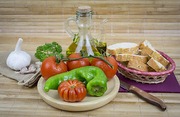 Image showing still life with olive oil,vegetables on wood table 