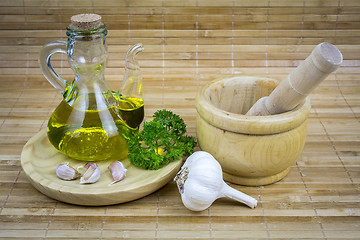 Image showing still life with olive oil,vegetables on wood table 