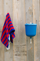 Image showing rural plastic hand wash tool towel hang wood wall 