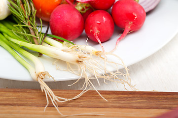 Image showing fresh vegetables and herbs on a plate 