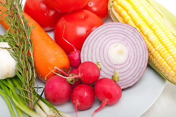 Image showing fresh vegetables and herbs on a plate 