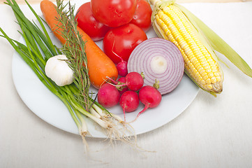 Image showing fresh vegetables and herbs on a plate 