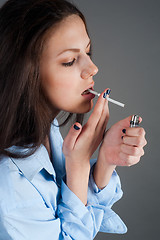 Image showing beautiful young brunette woman with cigarette