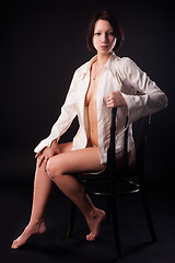 Image showing young sexy woman in white shirt on chair