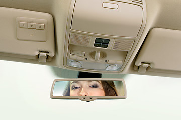 Image showing woman looks on the rear-view mirror