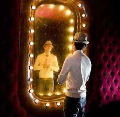 Image showing retro man looks on mirror