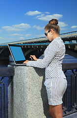 Image showing woman with laptop on quay