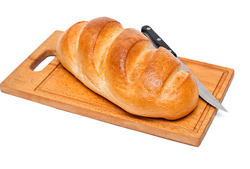 Image showing fresh bread with knife on breadboard