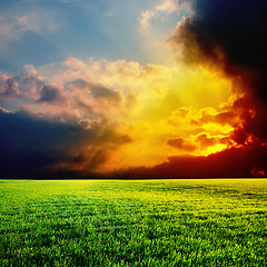 Image showing sunset over green field