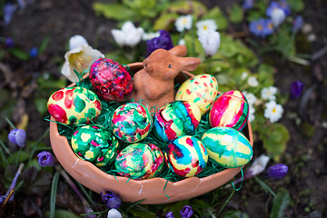 Image showing Easter basket amongst spring crocus flowers