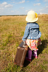Image showing lonely girl with suitcase. Back view