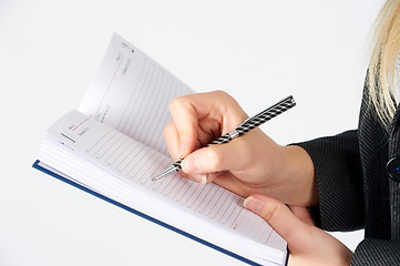 Image showing Woman writing in organizer