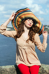 Image showing Young brunette in colorful hat