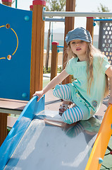 Image showing Little girl in denim peaky cap playing