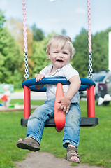 Image showing Swinging little boy