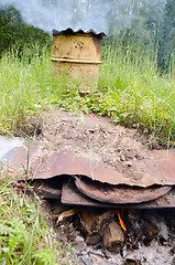 Image showing smoke smokehouse rusty barrel firewood burn 