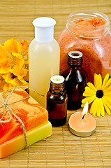 Image showing Oil and lotion with flowers and candle