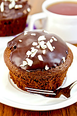 Image showing Cupcake chocolate on a white plate with a fork