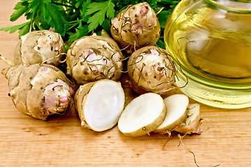 Image showing Jerusalem artichokes cut with oil on board