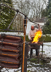 Image showing The Blacksmith Working