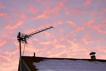 Image showing TV antenna against reddish cloudy sky