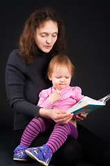 Image showing mother with daughter reading book