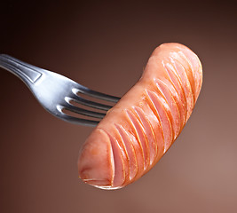 Image showing Grilled sausage on a fork