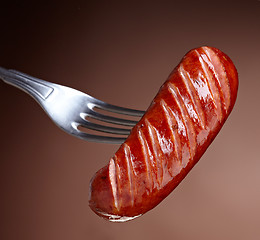 Image showing Grilled smoked sausage on a fork