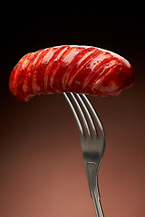 Image showing Grilled smoked sausage on a fork