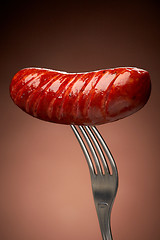 Image showing Grilled smoked sausage on a fork